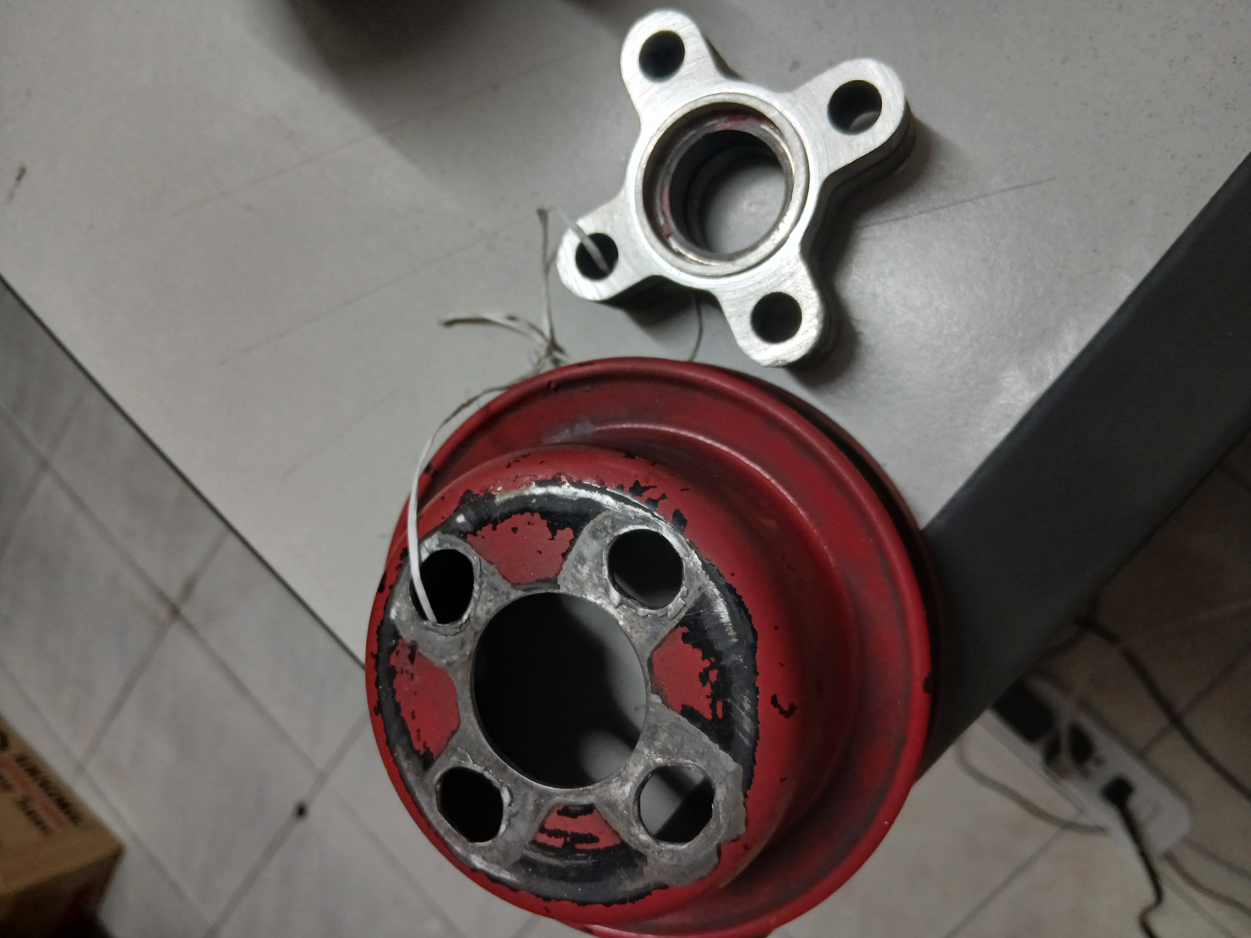 Engine water pump pulley (left) and a matching water pump flange